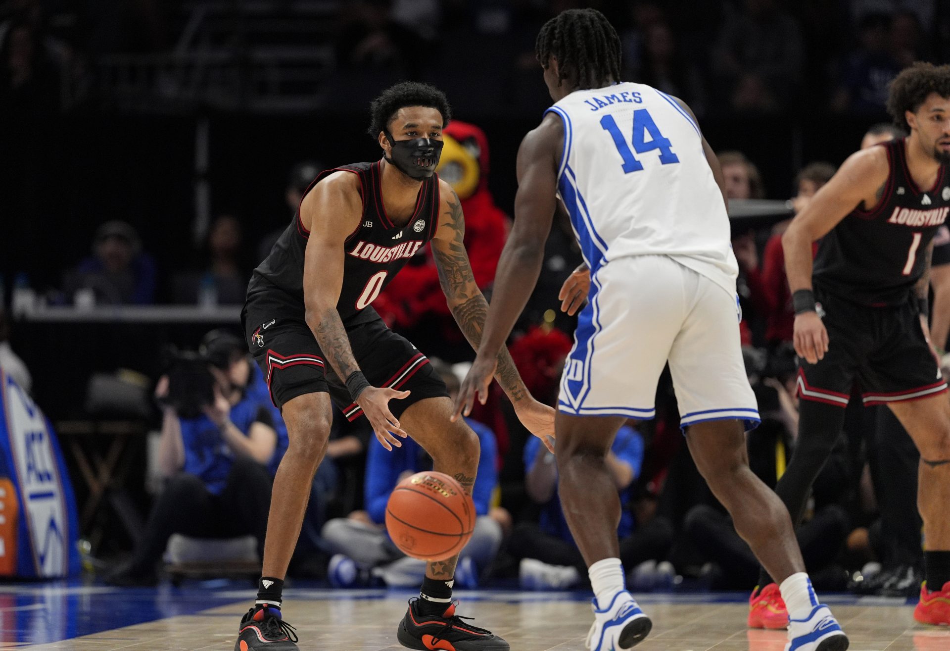 Louisville Cardinals forward James Scott (0) defends Duke Blue Devils guard Sion James (14) in the first half of the 2025 ACC Conference Championship game at Spectrum Center.