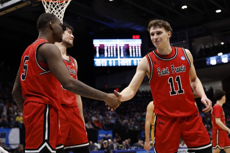 Saint Francis (Pa) Red Flash guard Daemar Kelly (5) celebrates a play with guard Riley Parker (11) in the second half against the Alabama State Hornets at UD Arena.