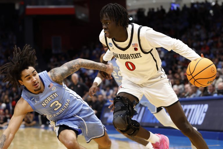 San Diego State Aztecs forward Magoon Gwath (0) dribbles the ball defended by North Carolina Tar Heels guard Elliot Cadeau (3) in the first half at UD Arena.