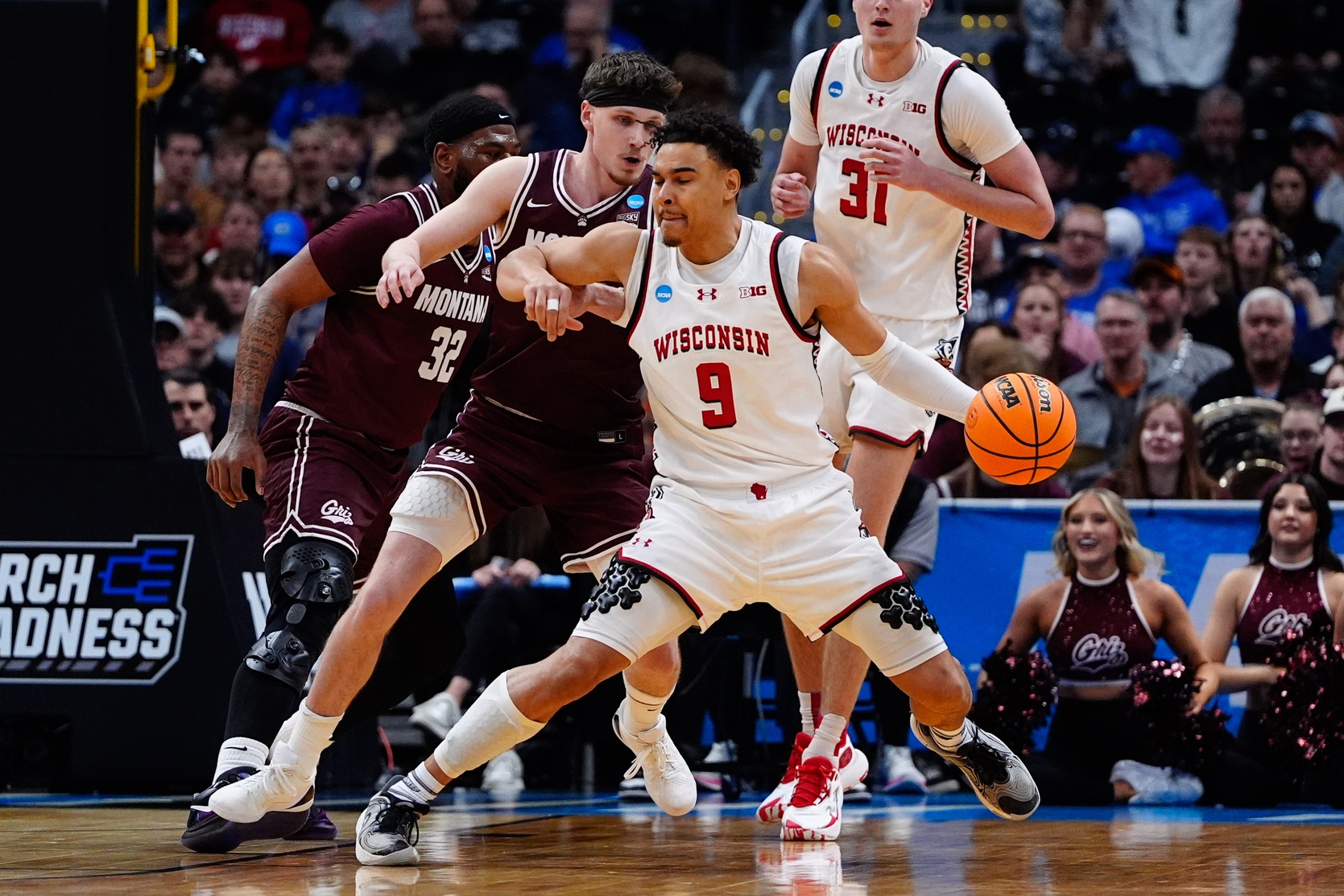 Montana Grizzlies guard Kai Johnson (1) defends against Wisconsin Badgers guard John Tonje (9) during the first half in the first round of the NCAA Tournament