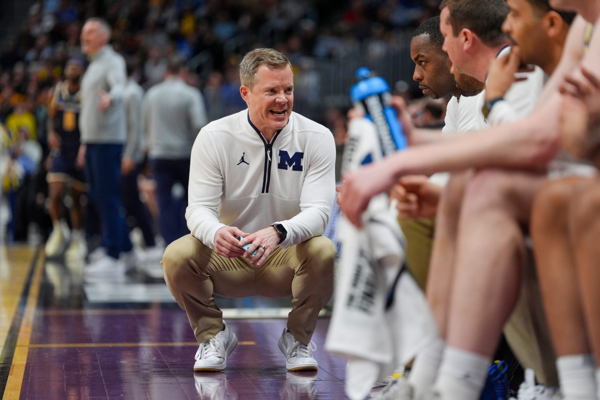 Michigan Wolverines head coach Dusty May talks to his asst. coaches during the second period of the first round of the NCAA tournament