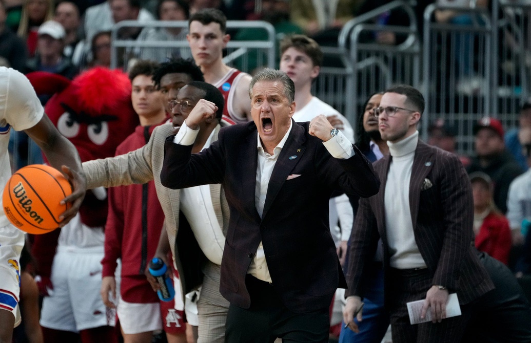 University of Arkansas coach John Calipari egging his players on against the Kansas Jayhawks in the first round of the NCAA tournament in Providence, RI.