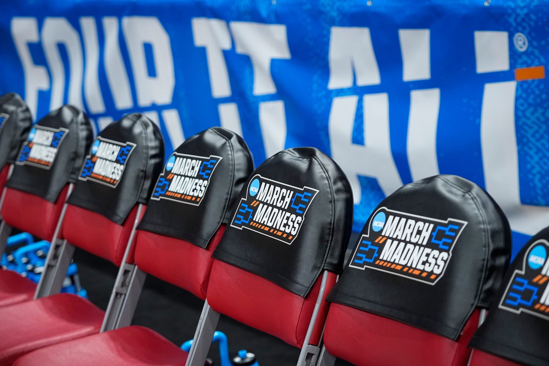 March Madness logos cover the bench chairs during the first round of the NCAA