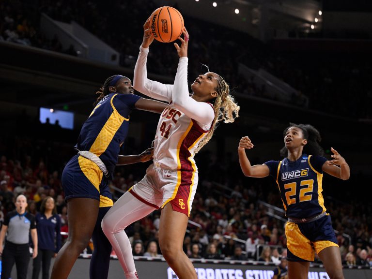 USC Trojans forward Kiki Iriafen (44) grabs a rebound between UNC Greensboro Spartans forward Yacine N'Diaye (5) and guard Nya Smith (22) during the second quarter of an NCAA Tournament game at Galen Center.