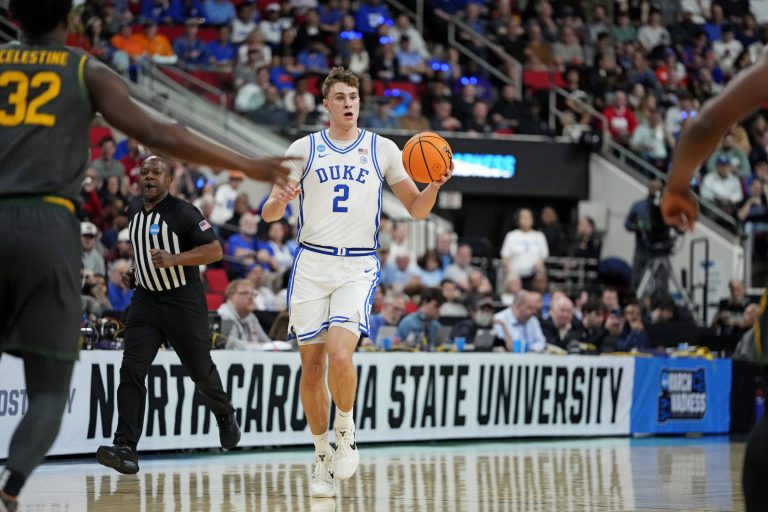 Duke Blue Devils forward Cooper Flagg (2) controls the ball as Baylor Bears guard Jalen Celestine (32) defends during the first half in the second round of the NCAA Tournament at Lenovo Center.
