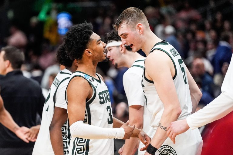 Michigan State guard Jaden Akins (3), left, and center Carson Cooper (15) celebrate 73-70 win over Ole Miss at the Sweet 16 round of NCAA tournament at State Farm Arena in Atlanta