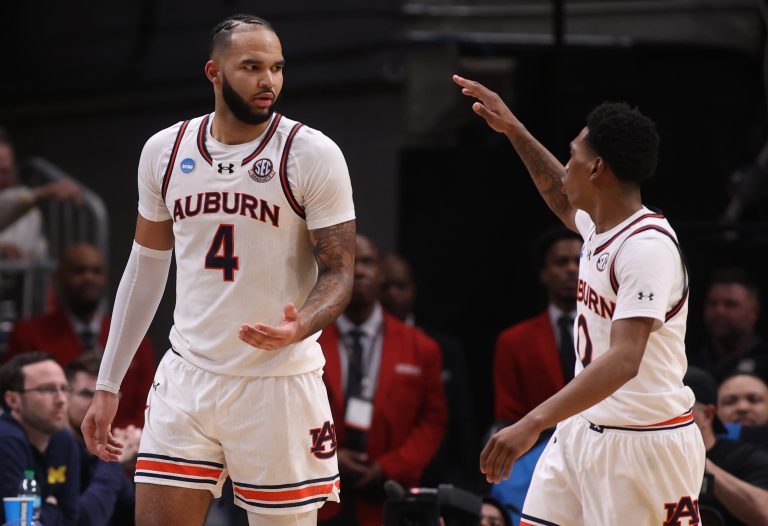 Auburn Tigers forward Johni Broome (4) celebrates with guard Tahaad Pettiford (0) in the second half of a South Regional semifinal of the 2025 NCAA tournament against the Michigan Wolverines at State Farm Arena.