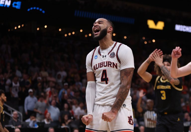 Auburn Tigers forward Johni Broome (4) reacts after a play in the second half of a South Regional semifinal of the 2025 NCAA tournament against the Michigan Wolverines at State Farm Arena.