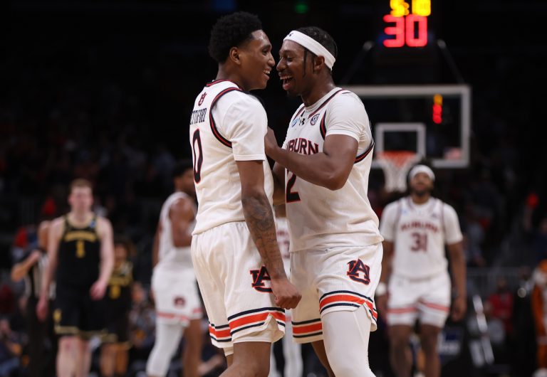 Auburn Tigers guard Denver Jones (2) celebrates with guard Tahaad Pettiford (0) after a basket in the second half of a South Regional semifinal of the 2025 NCAA tournament against the Michigan Wolverines at State Farm