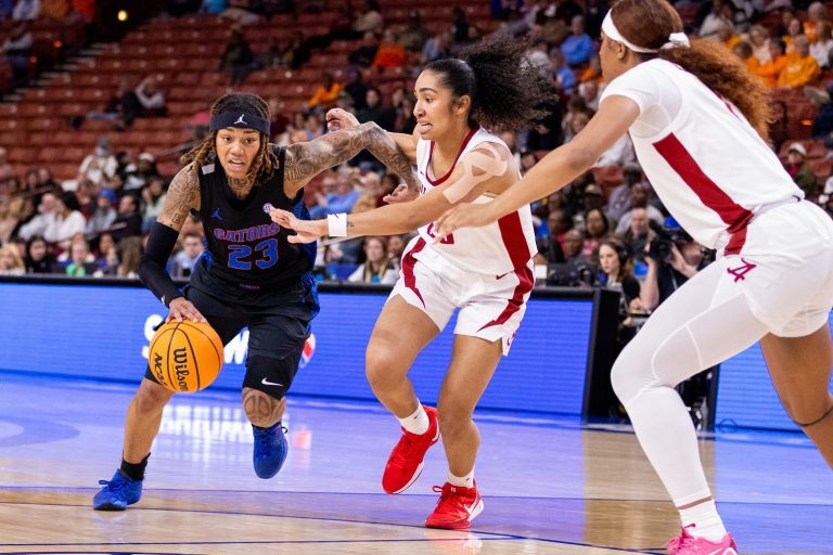 Florida Gators guard Liv McGill (23) drives on Alabama Crimson Tide guard Diana Collins (20) during the first half at Bon Secours Wellness Arena.