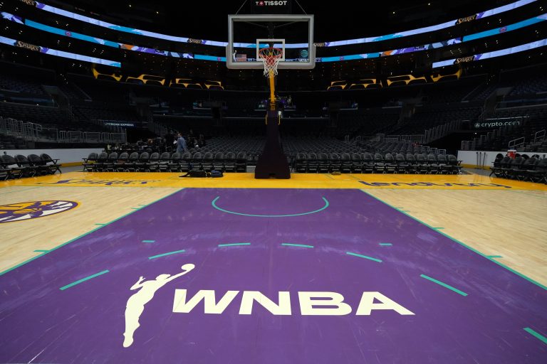 The WNBA logo on the court at Crypto.com Arena.