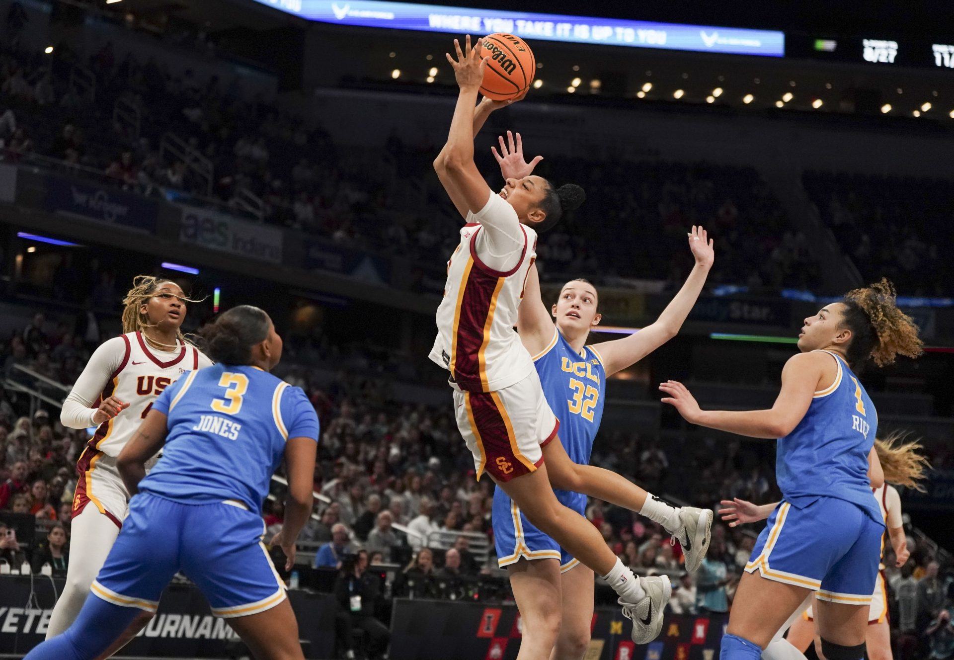 USC Trojans guard JuJu Watkins (12) jumps for a layup against UCLA Bruins forward Angela Dugalic (32) during the fourth quarter for the Big Ten Conference Championship at Gainbridge Fieldhouse.