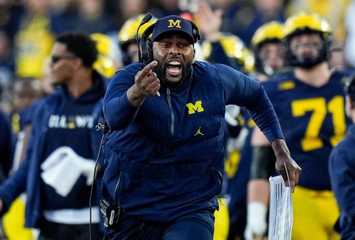 Michigan head coach Sherrone Moore challenges an incomplete pass intended for tight end Colston Loveland (not pictured) during the second half against Oregon at Michigan Stadium in Ann Arbor on Saturday, Nov. 2, 2024. Moore lost the challenge.