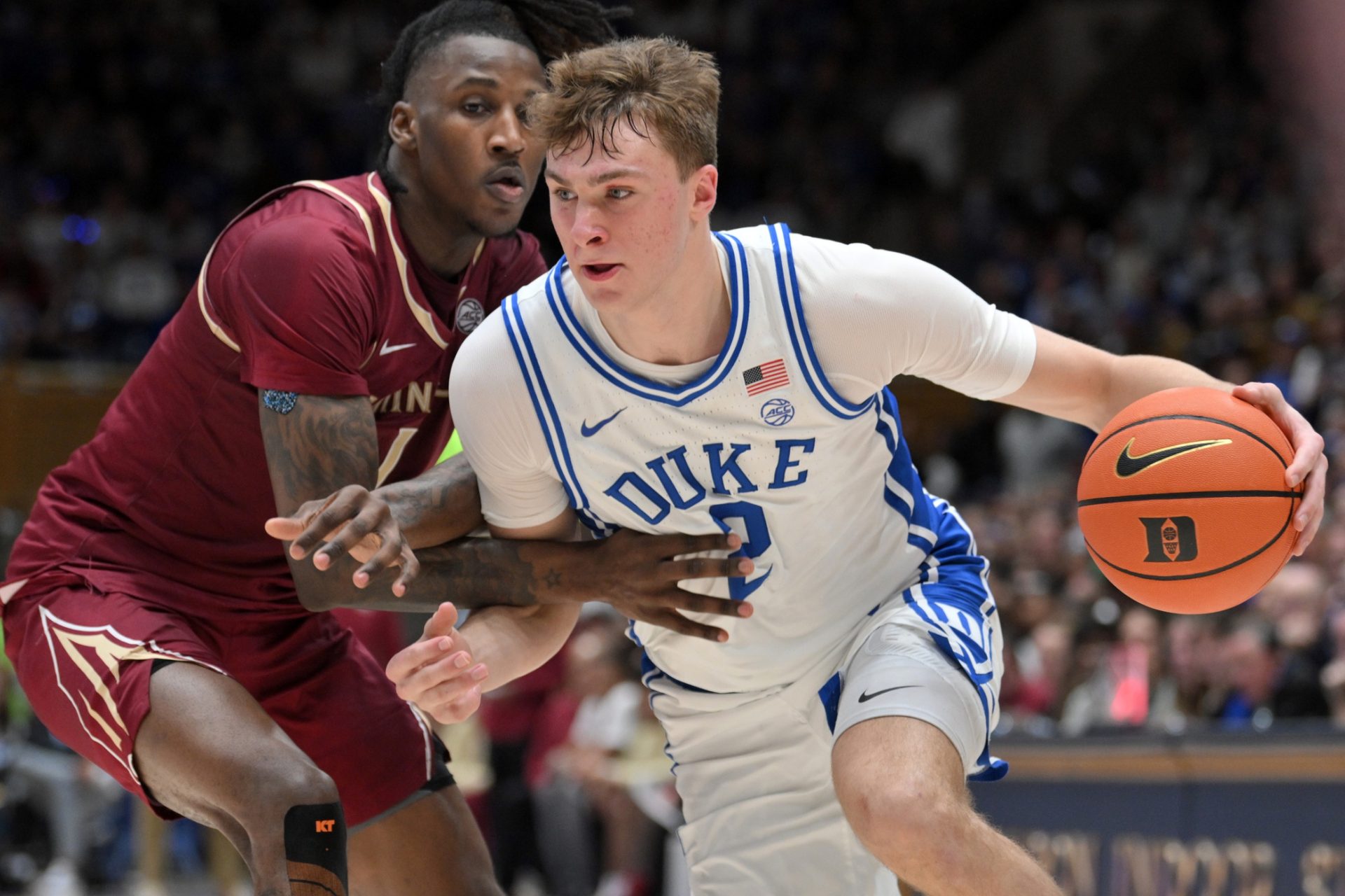 Duke Blue Devils forward Cooper Flagg (2) brings the ball around Florida State Seminoles guard Jamir Watkins (1) during the second half at Cameron Indoor Stadium. Blue Devils won 100-65.