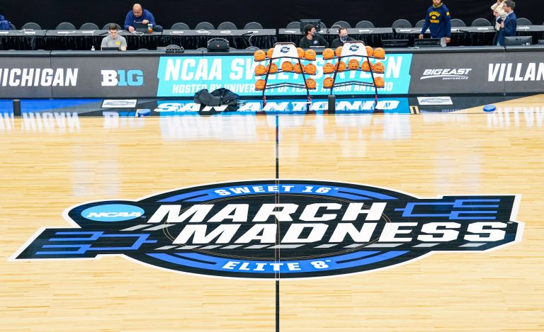 The Sweet 16/Elite 8 March Madness logo at center court of the AT&T Center prior to the Michigan Wolverines practice session.