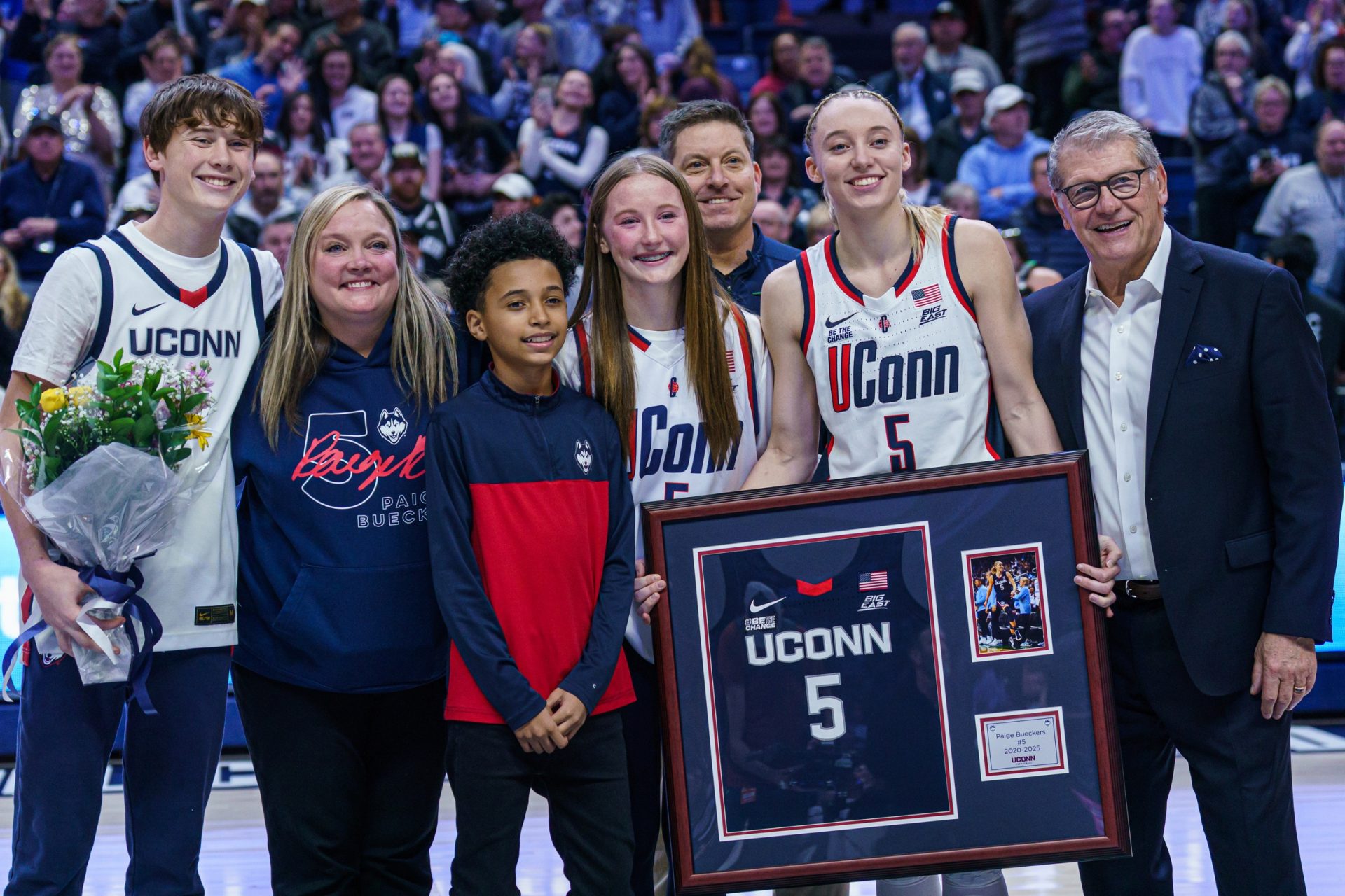 UConn Huskies guard Paige Bueckers (5) is recognized during senior night along side head coach Geno Auriemma and her family after the game against the Marquette Golden Eagles at Harry A. Gampel Pavilion.