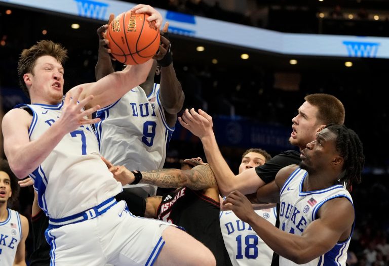 Duke Blue Devils guard Kon Knueppel (7) grabs a rebound as Louisville Cardinals forward Aboubacar Traore (25) and forward Noah Waterman (93) defend in the second half during the 2025 ACC Conference Championship game at Spectrum Center.