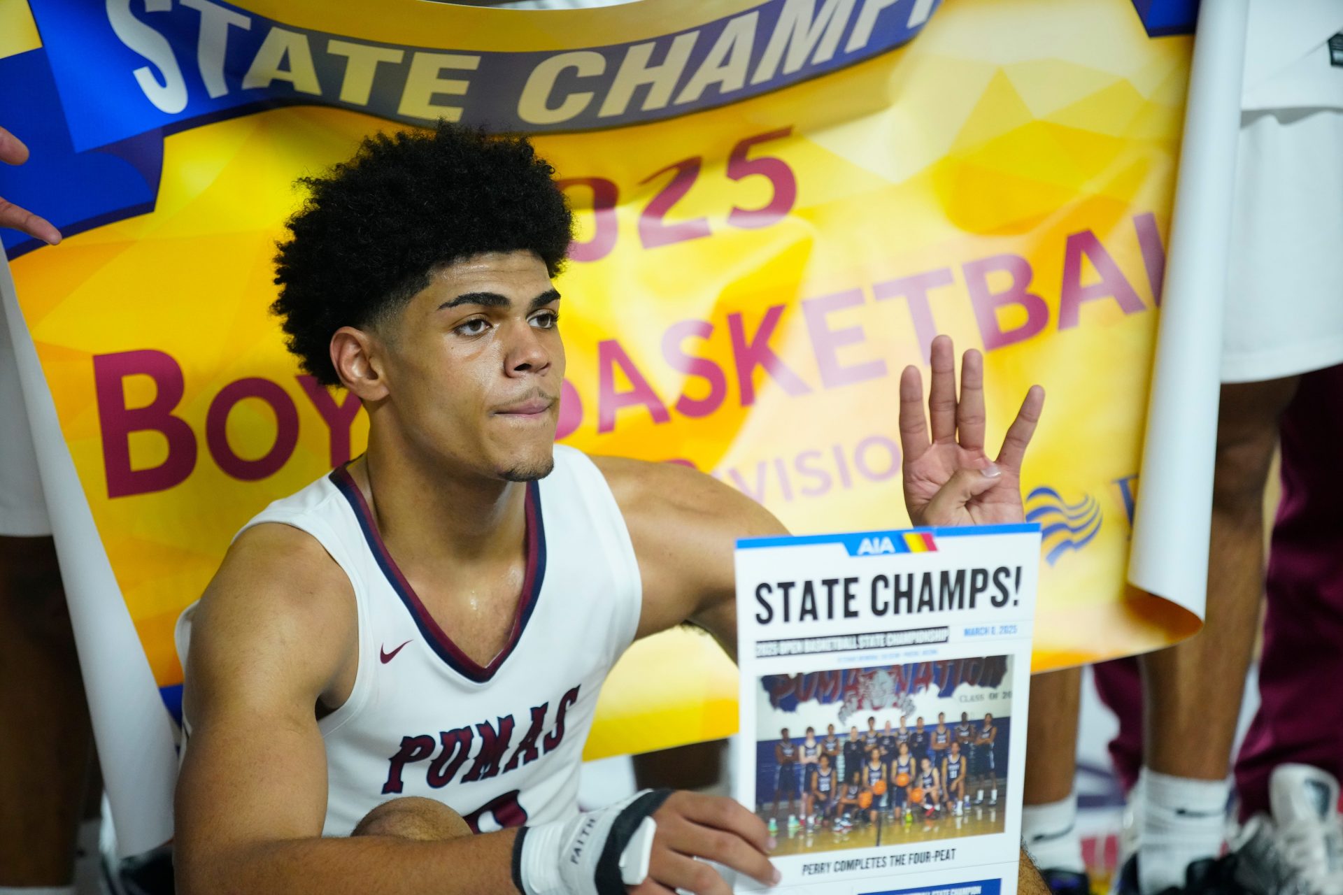 Perry forward Koa Peat holds up a four representing his fourth championship after winning the Boys Open State Championship game over Sunnyslope at Veterans Memorial Coliseum in Phoenix on March 8, 2025.