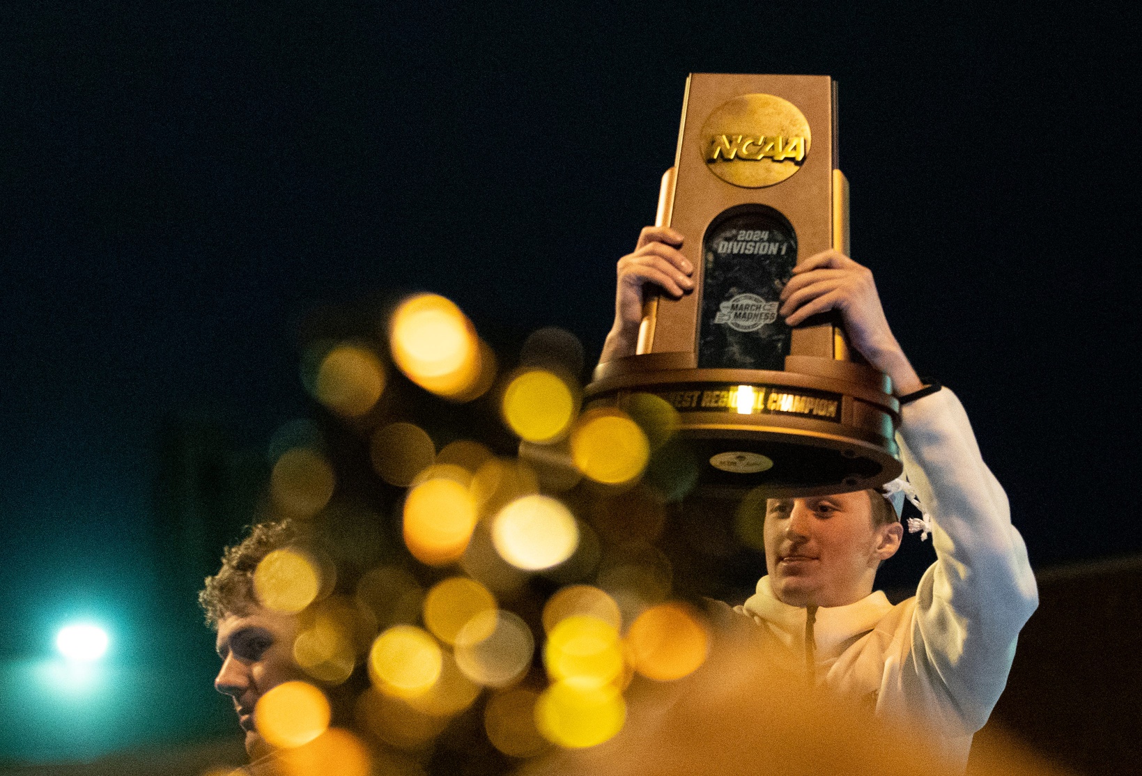 Purdue Boilermakers guard Fletcher Loyer (2) holds up a trophy after defeating Tennessee in the NCAA Tournament Elite Eight game, Sunday, March 31, 2024, at Purdue University Airport in West Lafayette, Ind.