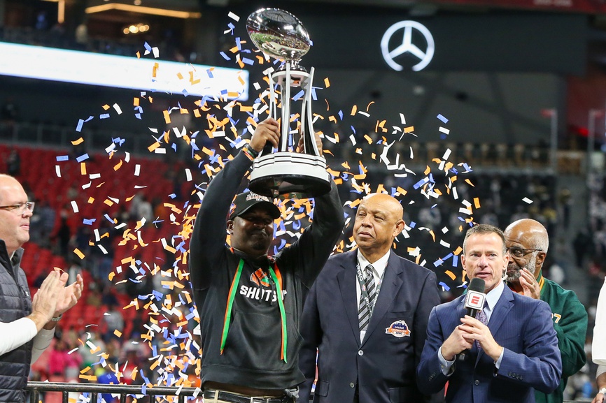 Florida A&M Rattlers head coach Willie Simmons holds up the Celebration Bowl trophy after a victory against the Howard Bison at Mercedes-Benz Stadium.