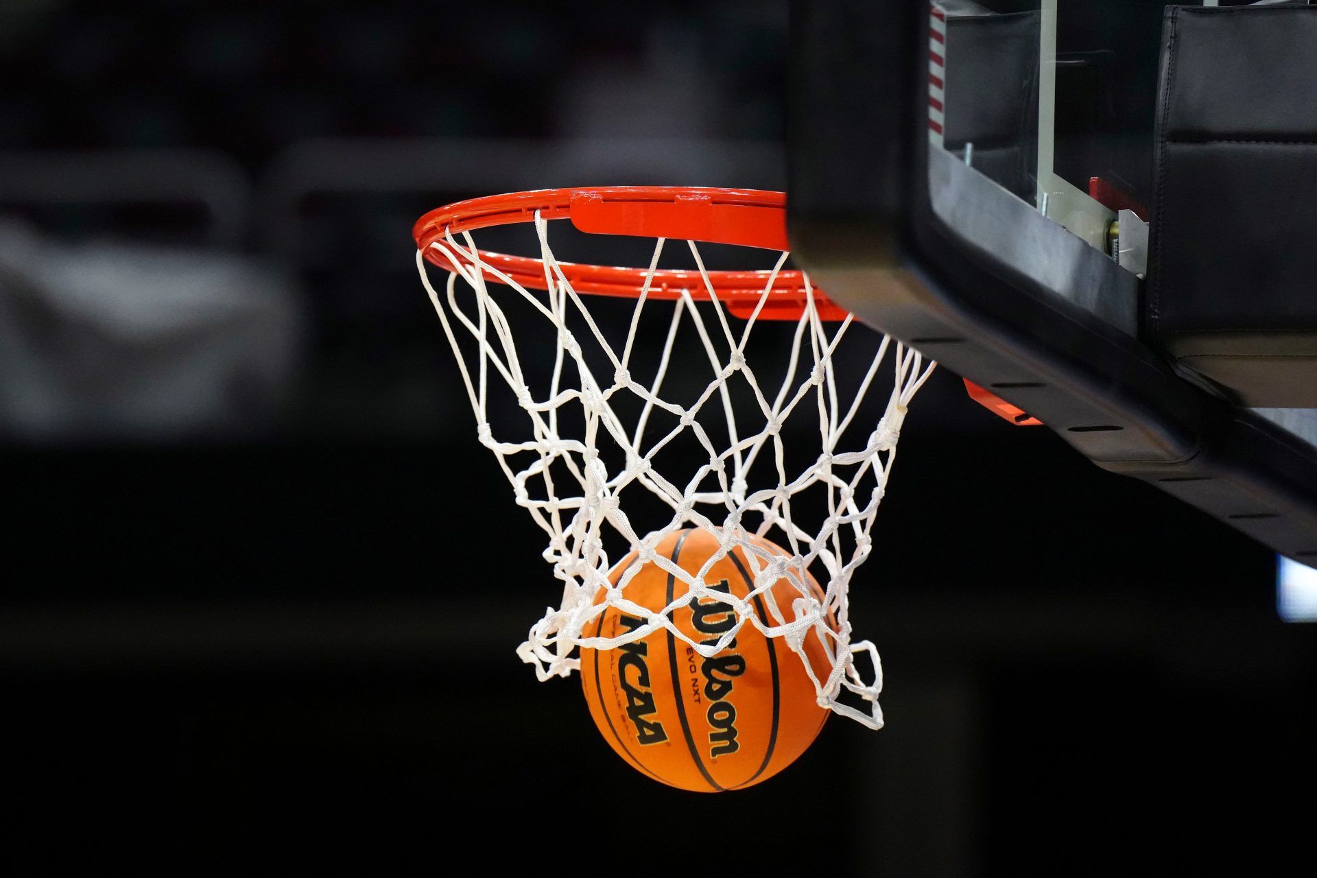 A Wilson official Evo NXT basketball with the NCAA Women's Final Four March Madness logo approaches the rim and net at Rocket Mortgage FieldHouse.