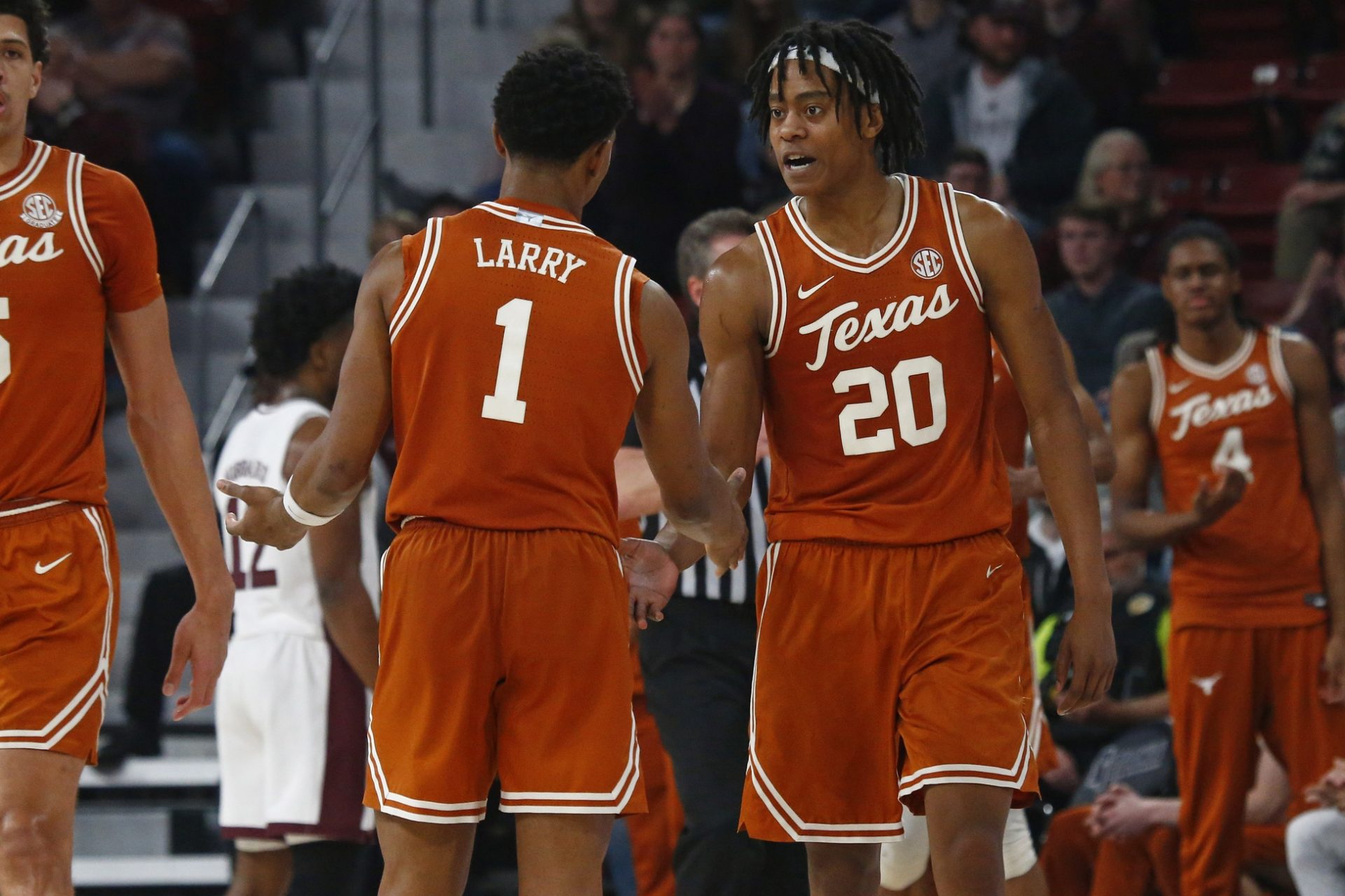 Texas Longhorns guard Tre Johnson (20) reacts with guard Julian Larry (1) during the second half against the Mississippi State Bulldogs at Humphrey Coliseum.