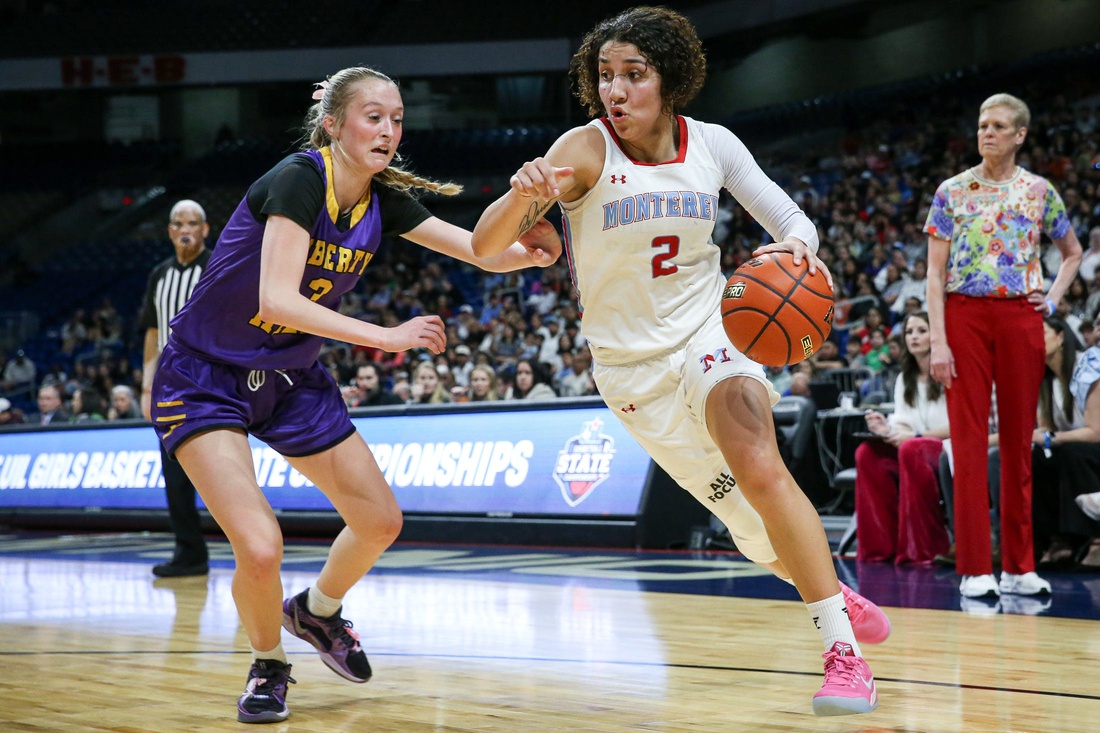 Monterey's Aaliyah Chavez dribbles past Liberty Hill's Reagan Robbins during the Class 5A Division II state championship girls basketball game