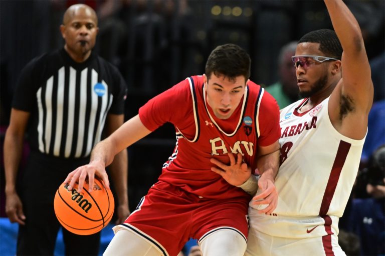 Robert Morris Colonials forward Alvaro Folgueiras (7) plays the ball defense day Alabama Crimson Tide guard Chris Youngblood (8) in the second half during the NCAA Tournament First Round at Rocket Arena.