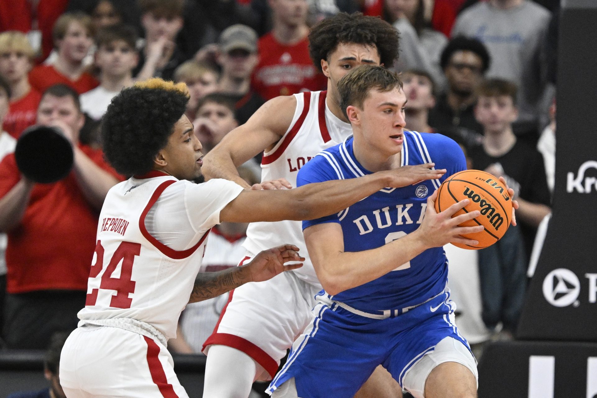 Duke Blue Devils guard Cooper Flagg (2) looks to pass under the pressure of Louisville Cardinals guard Chucky Hepburn (24) during the second half at KFC Yum! Center. Duke defeated Louisville 76-65.