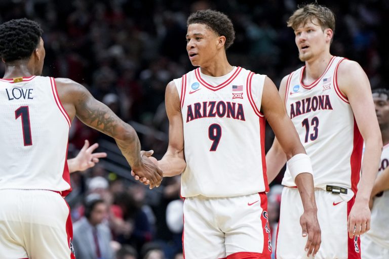 Arizona Wildcats guard Caleb Love (1) high-fives forward Carter Bryant (9) during a stop in play against the Oregon Ducks in the second half at Climate Pledge Arena.