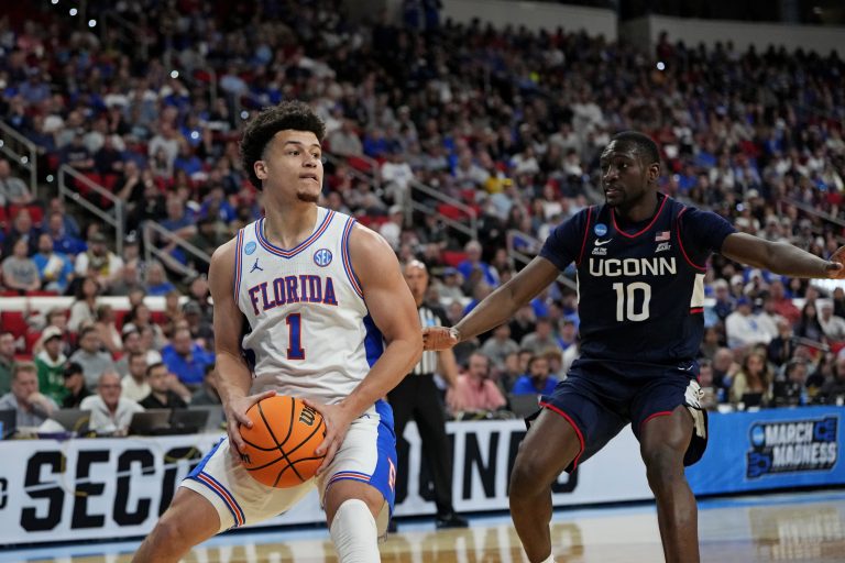 Florida Gators guard Walter Clayton Jr. (1) controls the ball as Connecticut Huskies guard Hassan Diarra (10) defends during the second half in the second round of the NCAA Tournament at Lenovo Center.