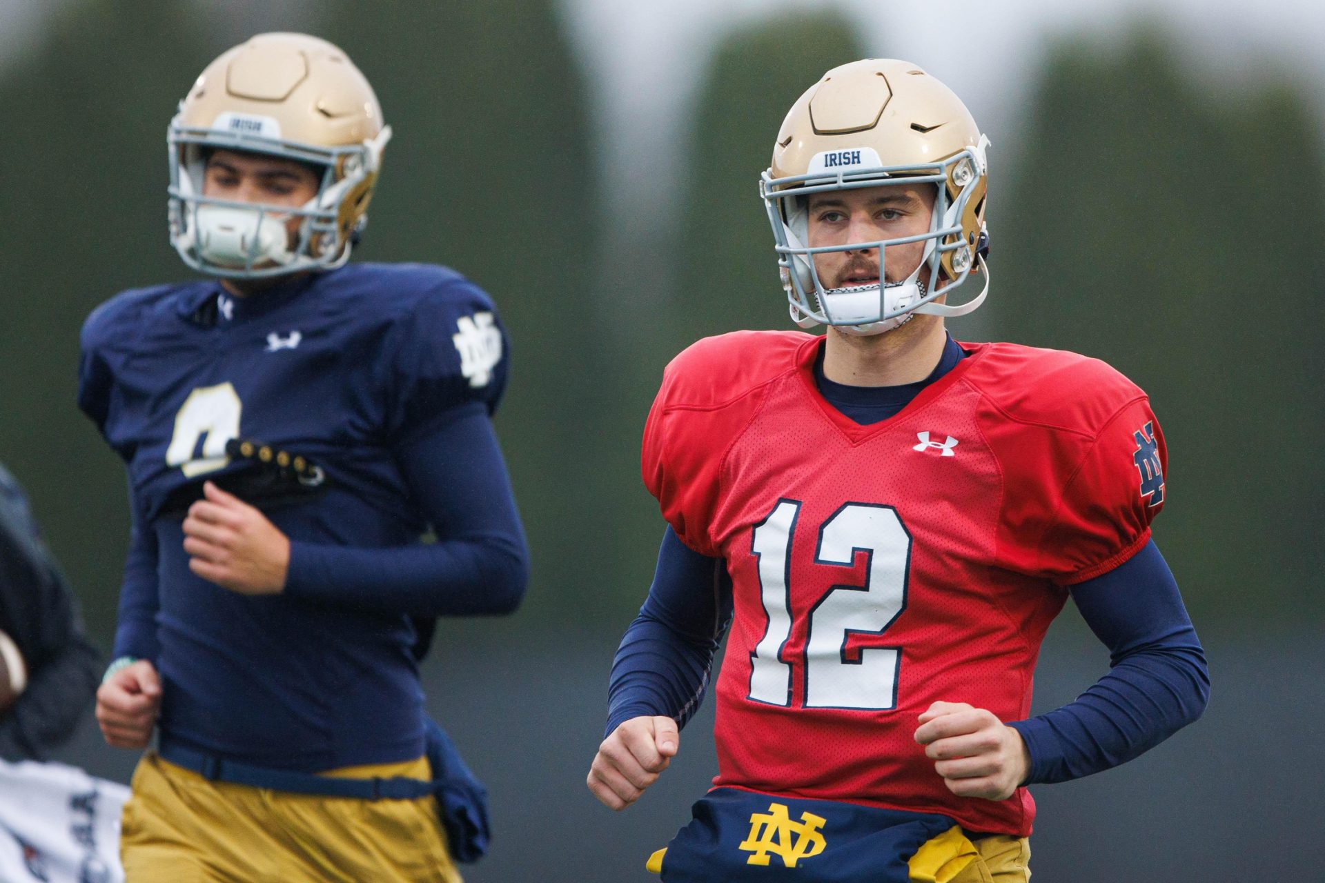 Notre Dame quarterback CJ Carr (12) runs to a drill during a Notre Dame football practice at Irish Athletic Center