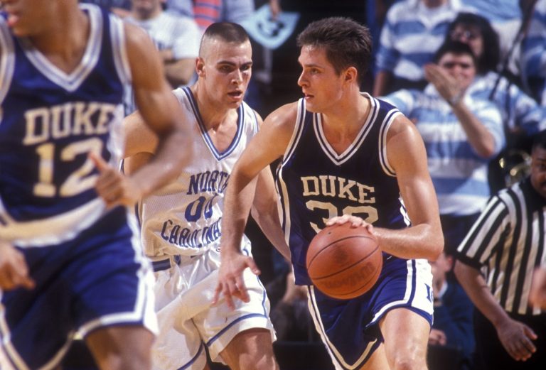 North Carolina Tar Heels center Eric Montross (00) defends as Duke Blue Devils center Christian Laettner (32) brings the ball up the court in the Tar Heels 75-73 victory against the Blue Devils at the Dean E. Smith Center.