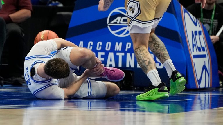 Duke Blue Devils forward Cooper Flagg (2) is injured in the first half at Spectrum Center.