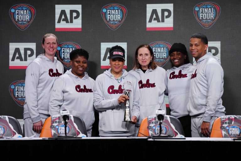 South Carolina Gamecocks coach Dawn Staley poses with staff after being named as the AP Coach of the Year at a press conference at Rocket Mortgage FieldHouse. From left: assistant coaches Mary Wooley and Jolette Law, Staley, associate head coach Lisa Boyer and assistant coaches Khadijah Sessions and Winston Gandy.