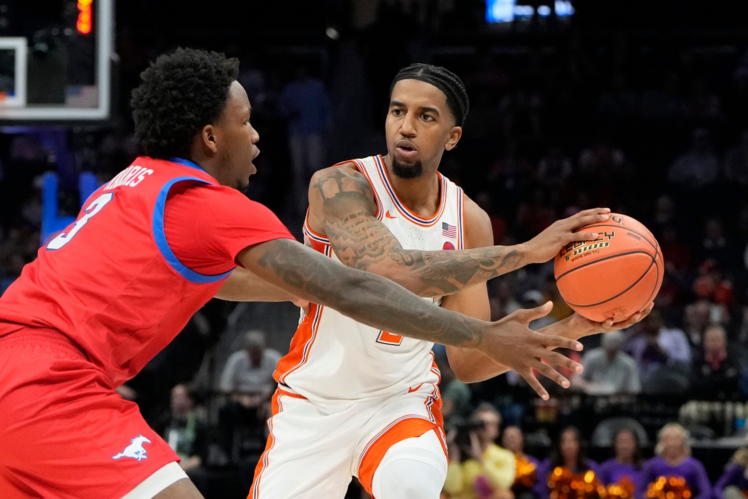 Clemson Tigers guard Dillon Hunter (2) looks to pass as Southern Methodist Mustangs guard Chuck Harris (3) defends in the first half at Spectrum Center.