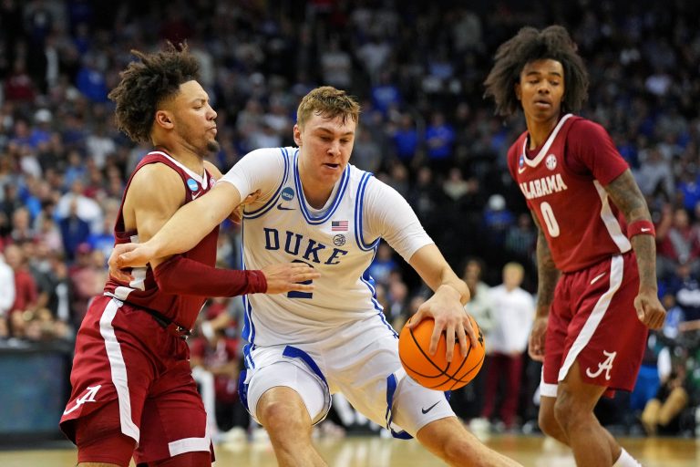Duke Blue Devils forward Cooper Flagg (2) drives to the basket against Alabama Crimson Tide guard Mark Sears (1) during the second half in the East Regional final of the 2025 NCAA tournament at Prudential Center.