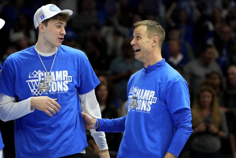 Duke Blue Devils forward Cooper Flagg (2) and head coach Jon Scheyer celebrate after winning the 2025 ACC Conference Championship game against the Louisville Cardinals at Spectrum Center.