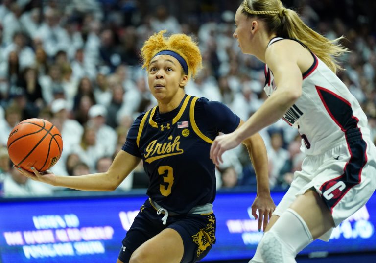 Notre Dame Fighting Irish guard Hannah Hidalgo (3) drives the ball against UConn Huskies guard Paige Bueckers (5) in the first half at Harry A. Gampel Pavilion.