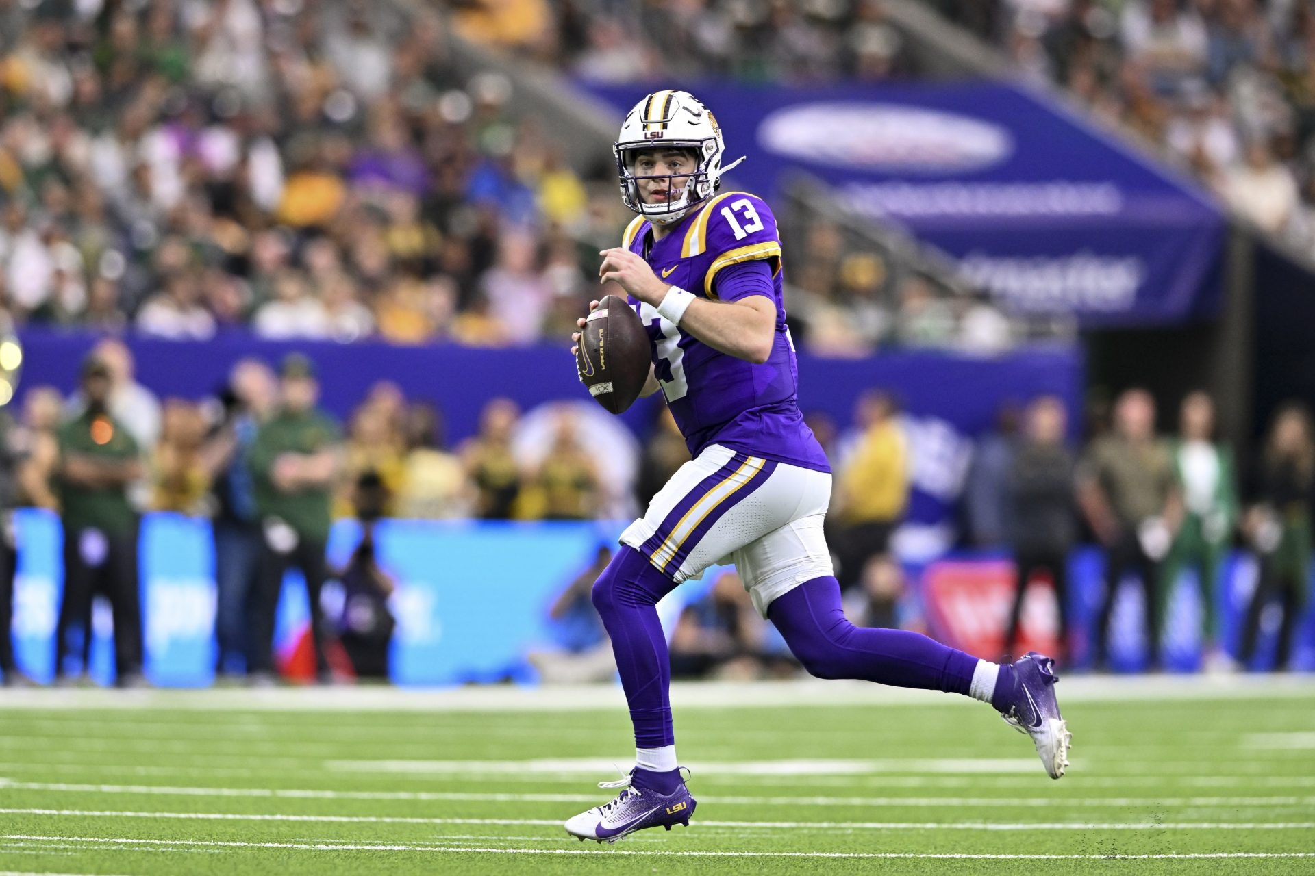 LSU Tigers quarterback Garrett Nussmeier (13) runs the ball during the first half against the Baylor Bears at NRG Stadium.