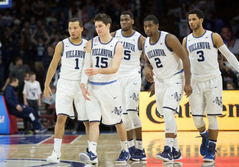 Villanova Wildcats guard Jalen Brunson (1) and guard Ryan Arcidiacono (15) and forward Darryl Reynolds (45) and forward Kris Jenkins (2) and guard Josh Hart (3) walk onto the court after a timeout against the Providence Friars at Wells Fargo Center. The Providence Friars won 82-76 in overtime.