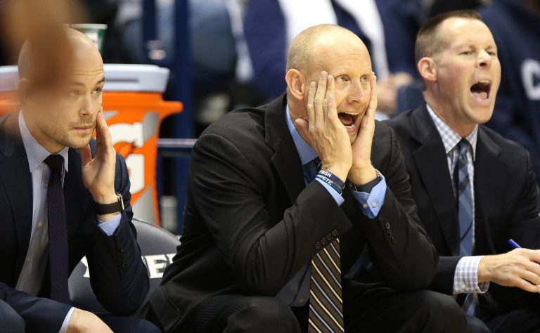 Xavier assistant coach Luke Murray (left), head coach Chris Mack and associate head coach Travis Steele (right) watch the Musketeers take on Northern Iowa