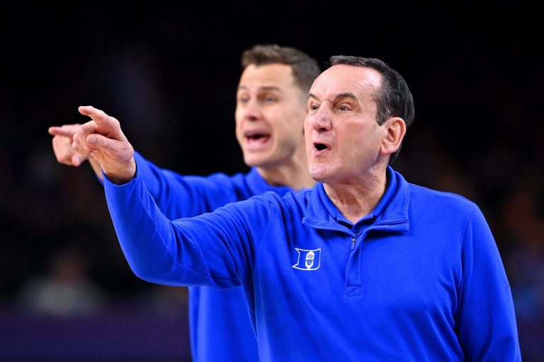 Duke Blue Devils head coach Mike Krzyzewski and associate head coach Jon Scheyer instruct their team against the North Carolina Tar Heels during the first half during the 2022 NCAA men's basketball tournament Final Four semifinals at Caesars Superdome.