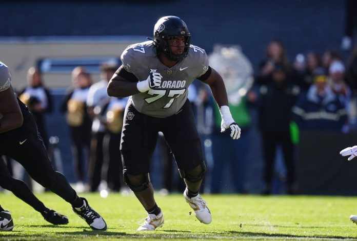 Colorado Buffaloes offensive tackle Jordan Seaton (77) looks to defend during the first quarter against the Utah Utes at Folsom Field.