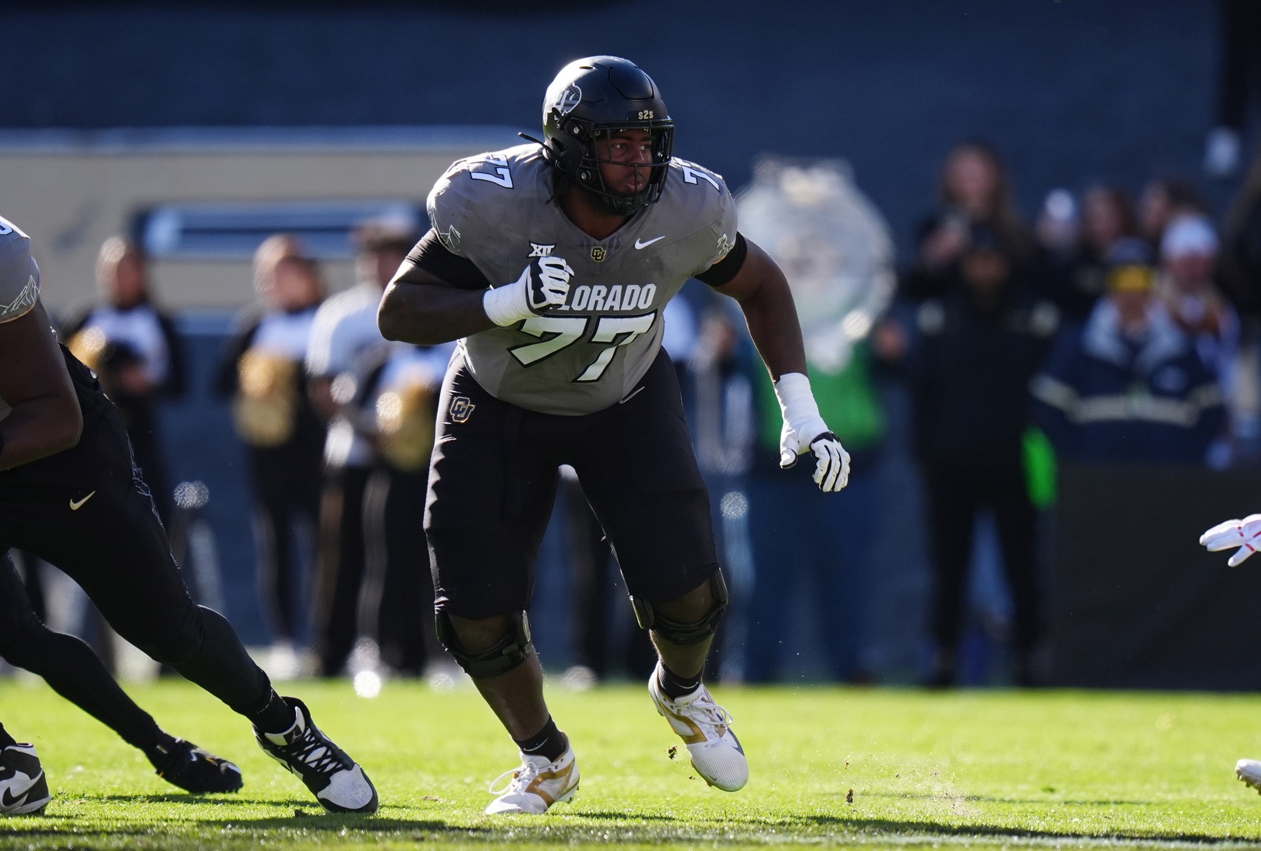 Colorado Buffaloes offensive tackle Jordan Seaton (77) looks to defend during the first quarter against the Utah Utes at Folsom Field.