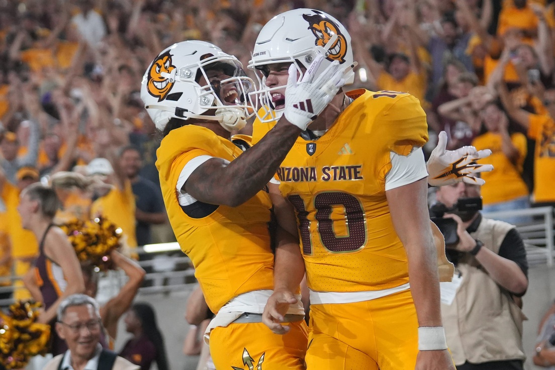 ASU Sun Devils quarterback Sam Leavitt (10) celebrates his touchdown run with teammate Jordyn Tyson