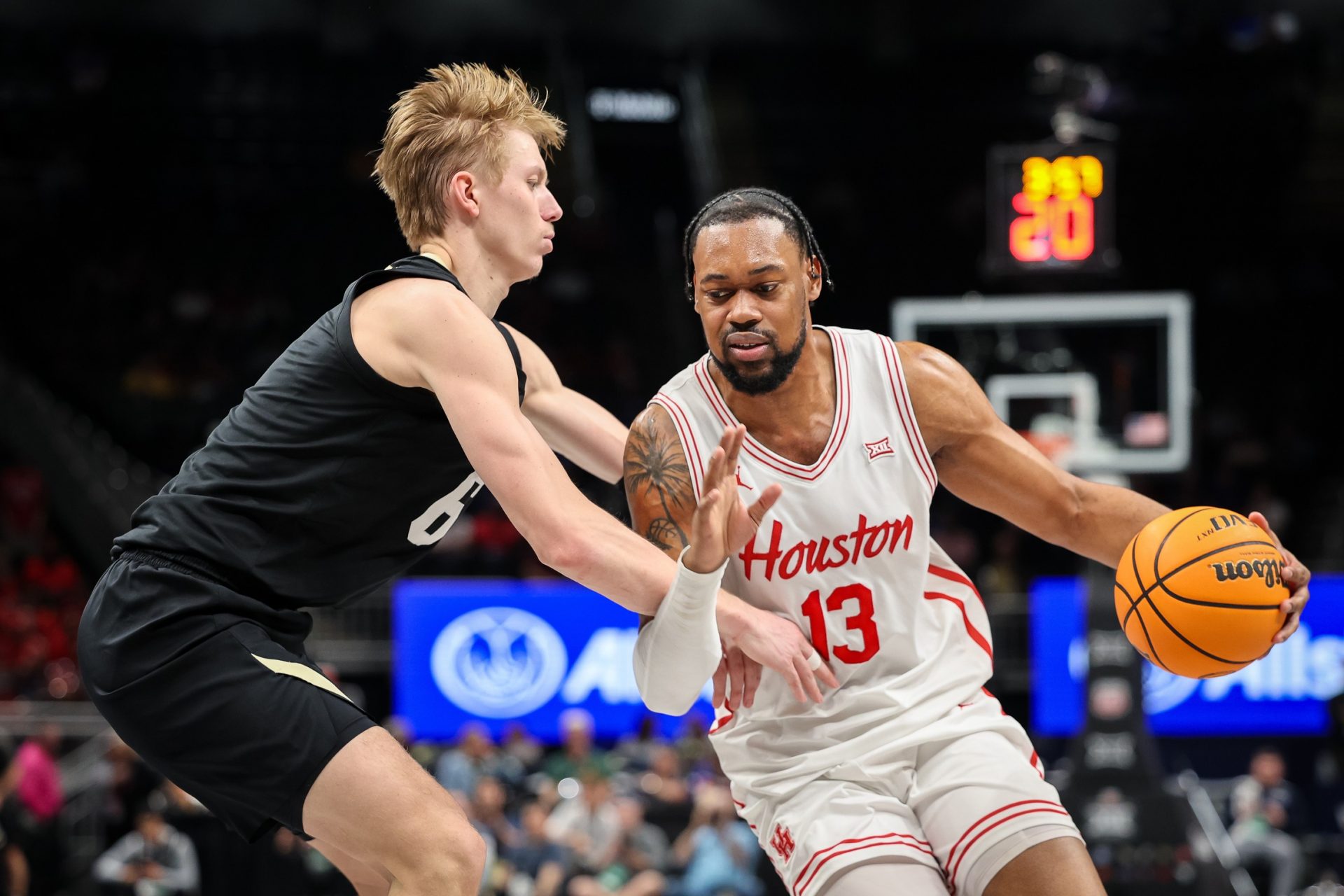 Houston Cougars forward J'Wan Roberts (13) drives to the basket around Colorado Buffaloes forward Trevor Baskin (6) during the first half at T-Mobile Center.