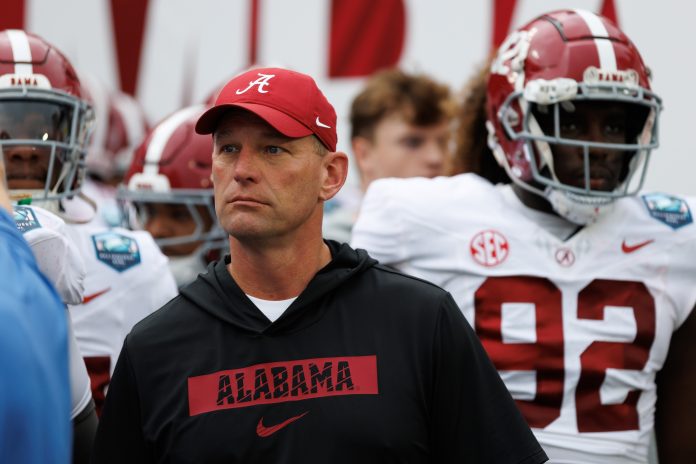 Alabama Crimson Tide head coach Kalen DeBoer looks on before running onto the field before a game against the Michigan Wolverines at Raymond James Stadium.