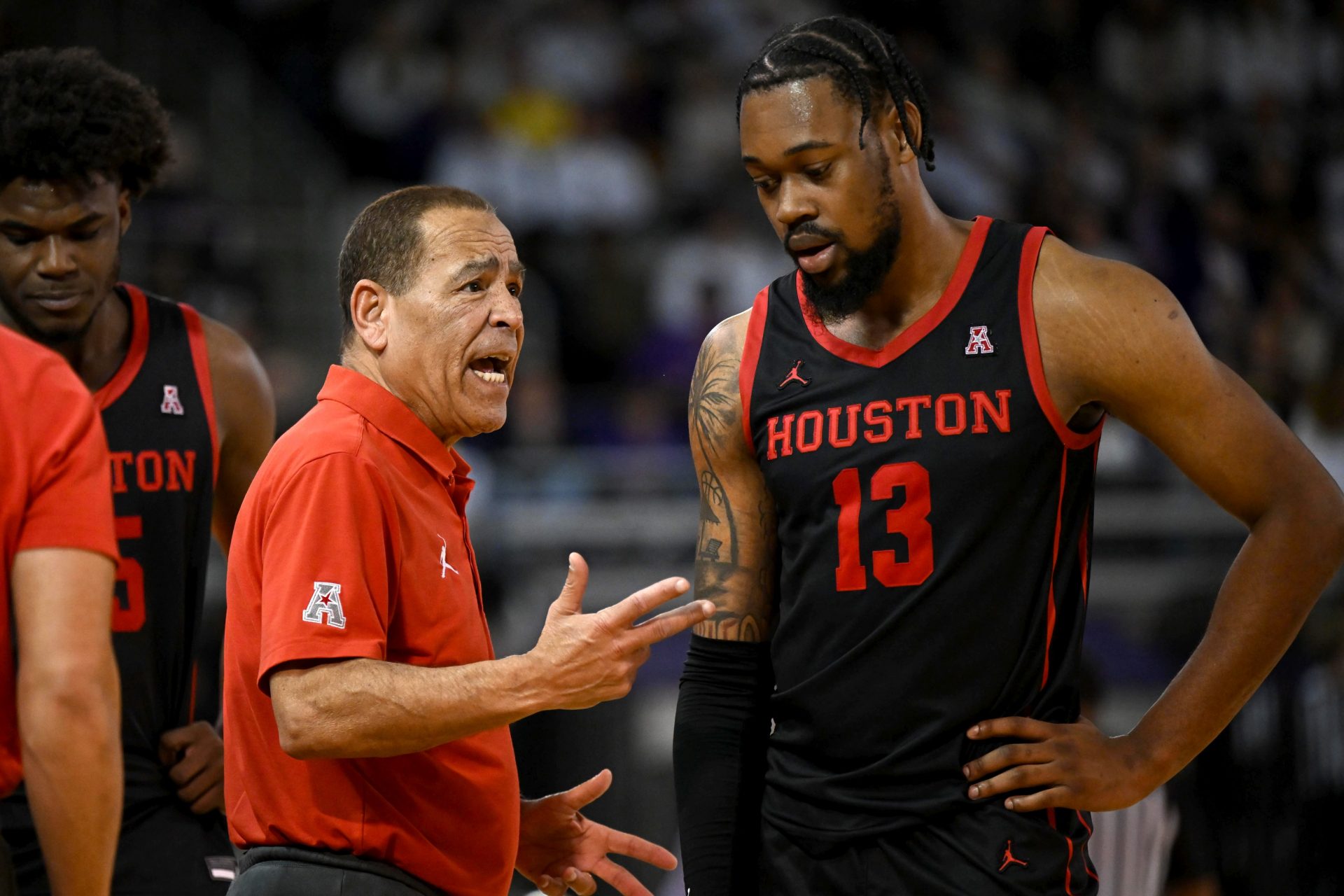 Houston Cougars head coach Kelvin Sampson discusses a play with forward J'Wan Roberts (13) during the second half at Williams Arena at Minges Coliseum.