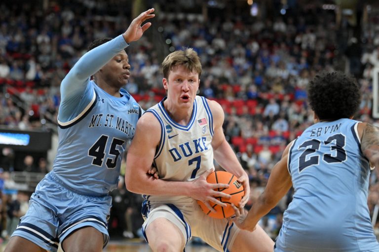 Mount St. Mary's Mountaineers guard Xavier Lipscomb (45) and guard Javon Ervin (23) defend Duke Blue Devils guard Kon Knueppel (7) during the second half in the first round of the NCAA Tournament at Lenovo Center.